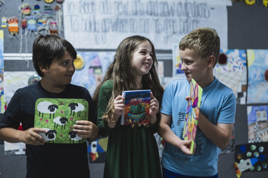 Collaborate with Art to Remember for an Art Fundraiser for Schools image shows group of kids smiling