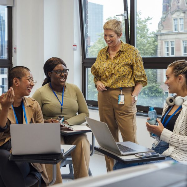 Group of medical students in a classroom in a hospital studying for their medical degree. They are at a healthcare facility in Newcastle Upon Tyne, North East England. A female teacher is supervising the students.